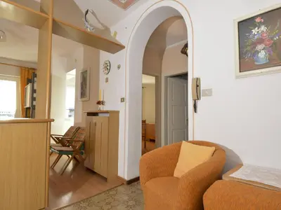 an archway in a living room with a couch and chair at Apartment Casa Deluca by Interhome in Pozza di Fassa