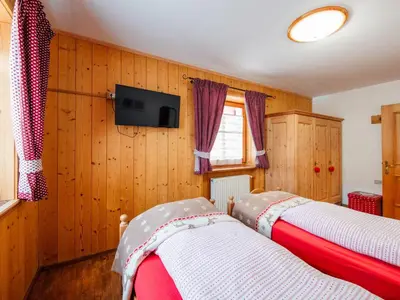 an archway in a room with a bed and a bedroom at Apartment Brunel-1 by Interhome in Pozza di Fassa