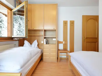 a large white bed in a room with a window at Apartment Ardoney-1 by Interhome in Campitello