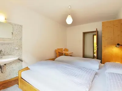 a bedroom with two beds and a sink at Apartment Puntea by Interhome in Ortisei