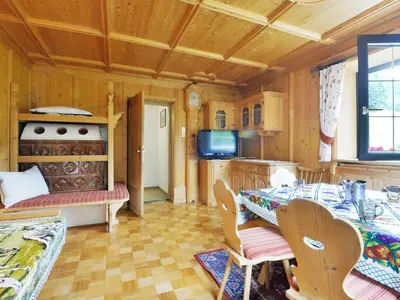 a kitchen and dining room with a table and chairs at Apartment Puntea by Interhome in Ortisei
