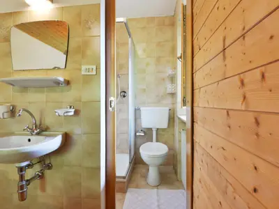 a bathroom with a tub and a sink and a toilet at Apartment Puntea by Interhome in Ortisei