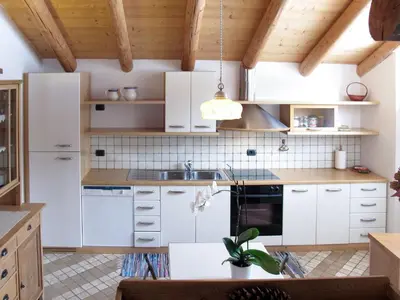 a bedroom with a large bed and a window at Apartment Chalet Baita Tabià Dolomites by Interhome in Bellamonte