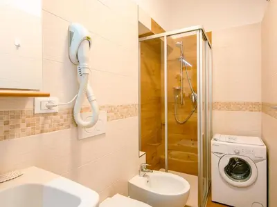 a bathroom with a shower and a toilet and a sink at Apartment Pederiva - SOF740 by Interhome in Soraga