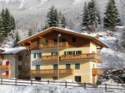 a apartment building with a balcony in the snow at Apartment Pederiva - SOF740 by Interhome in Soraga