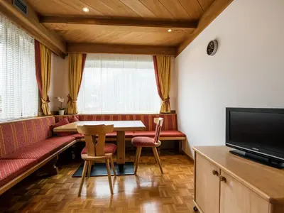 a kitchen and dining room with a table and chairs at Apartment Ornella-4 by Interhome in Ortisei