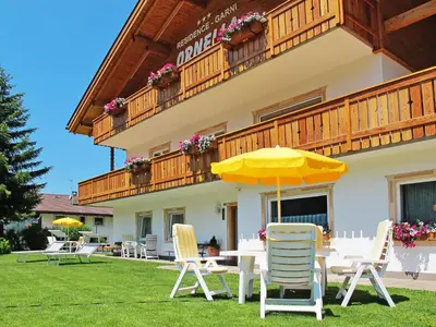a log cabin with a balcony in the snow at Apartment Ornella-4 by Interhome in Ortisei