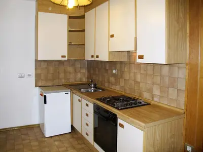 a kitchen with white cabinets and a sink and a stove at Apartment Zollerhof - OLA192 by Interhome in Valdaora di Sotto