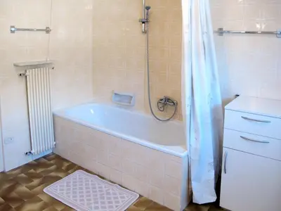 a bathroom with a bath tub and a shower at Apartment Deluca by Interhome in Pozza di Fassa