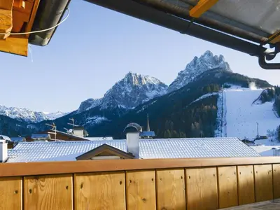 a view from the balcony of a ski resort with mountains at Apartment Deluca by Interhome in Pozza di Fassa