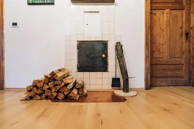 a room with a pile of wood next to a door at Untersteinhaus in Aldino