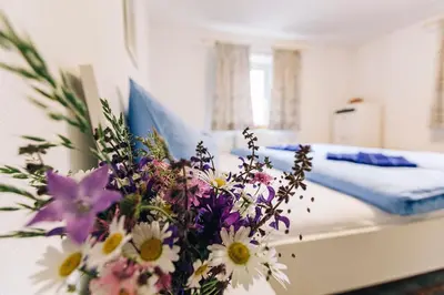 a bedroom with a bed with a bouquet of flowers at Untersteinhaus in Aldino