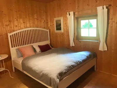 a bedroom with a bed and a window in it at Bauernhaus Spathen in Santa Valburga St. Walburg