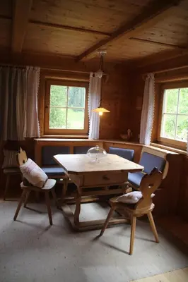 a wooden table and two chairs in a room at Bauernhaus Spathen in Santa Valburga St. Walburg