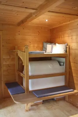two bunk beds in a log cabin at Bauernhaus Spathen in Santa Valburga St. Walburg