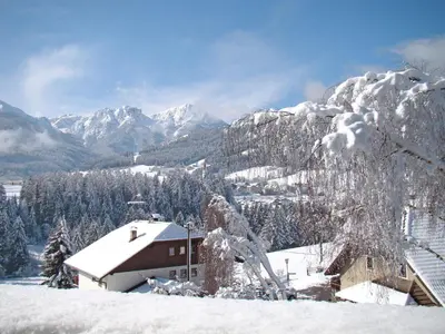 a snow covered mountain with a house in the foreground at Apartment Zollerhof - OLA190 by Interhome in Valdaora di Sotto