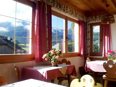 a dining room with two tables and two windows at Apartment Zollerhof - OLA190 by Interhome in Valdaora di Sotto
