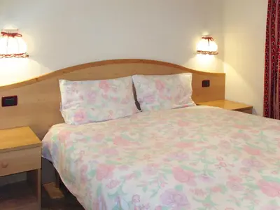 a kitchen with a table and a television and a kitchen with a table and chairs at Apartment Spinel by Interhome in Campitello