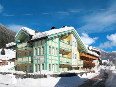 a colorful house with snow on the ground at Apartment Spinel by Interhome in Campitello