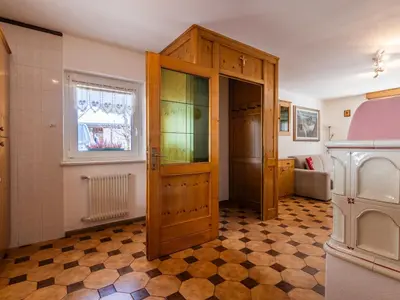 a bathroom with a large wooden door in a room at Apartment Cesa Micheluzzi - CZI712 by Interhome in Penia