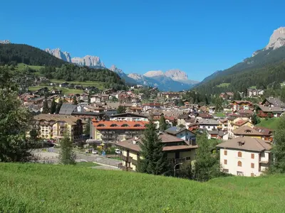 a town on a hill with mountains in the background at Apartment Lola by Interhome in Moena