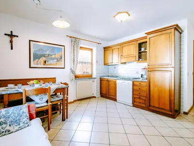 a kitchen with a table and a dining room at Apartment Valentini by Interhome in Mazzin