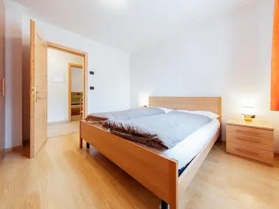 a bedroom with a bed and an open door at Apartment Brunel - SOF772 by Interhome in Soraga