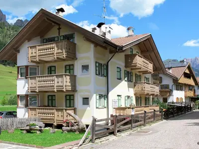 a house covered in snow with a pile of snow at Apartment Maura-1 by Interhome in Pozza di Fassa