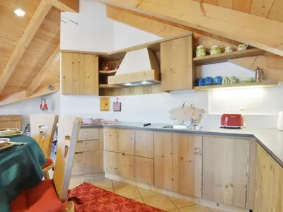 a living room with a couch and a tv at Apartment Maura-1 by Interhome in Pozza di Fassa