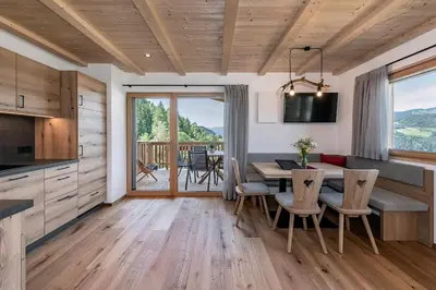 a kitchen and dining room with a table and chairs at Gschlunerhof in Castelrotto
