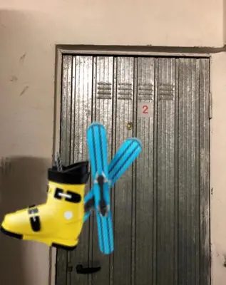 a door with a hat and a pair of scissors at Appartamento AB in Passo San Pellegrino