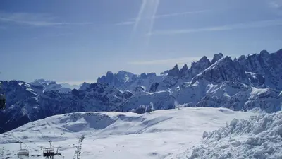 a ski lift on top of a snow covered mountain at Appartamento AB in Passo San Pellegrino
