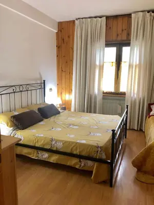 a bedroom with a large bed in a room at Appartamento AB in Passo San Pellegrino