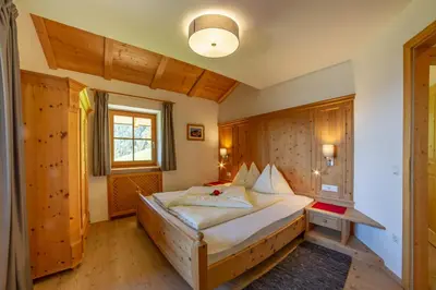 a bedroom with a large bed in a room at Prackfiedererhof in Villandro