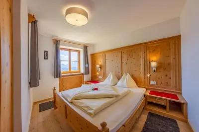 a bedroom with a large bed in a room at Prackfiedererhof in Villandro