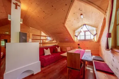 a living room with a red couch and a window at Prackfiedererhof in Villandro