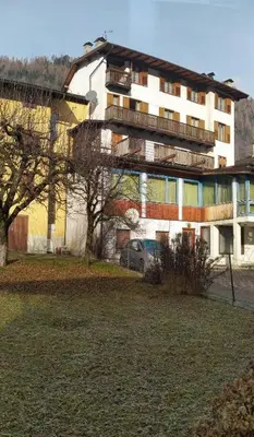 a building with a car parked in front of it at Casa Renzo - Dolomiti - Trentino in Mezzano