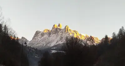a mountain with snow on the top of it at Casa Renzo - Dolomiti - Trentino in Mezzano