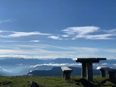 two benches sitting on top of a hill with mountains at Laugen B&B in San Felice