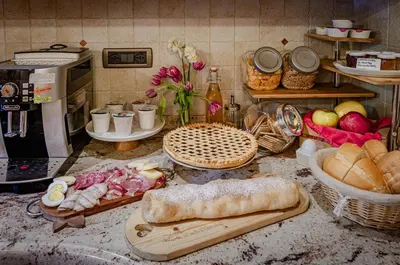 a kitchen counter with bread and food on it at Agritur Coryletum in Coredo