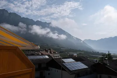 a view of a mountain with solar panels on roofs at Fewo Dreiraum im Haus Götsch 6 in Parcines