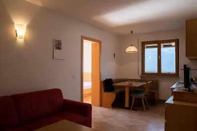 a living room with a couch and a table at Fewo Dreiraum im Haus Götsch 6 in Parcines