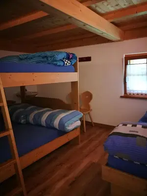 a bedroom with two bunk beds in a cabin at Rifugio Stella Alpina Spiz Piaz per escursionisti in Gardeccia - San Giovanni di Fassa