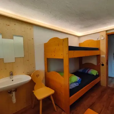a bathroom with a bunk bed and a sink at Rifugio Stella Alpina Spiz Piaz per escursionisti in Gardeccia - San Giovanni di Fassa