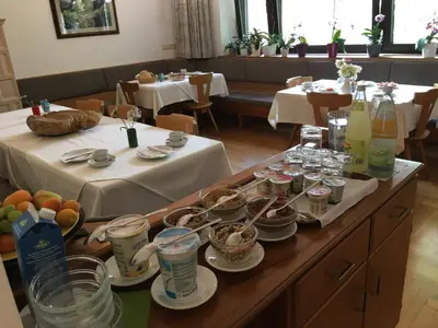 a table with plates of food and drinks on it at Garni Maria in Varna