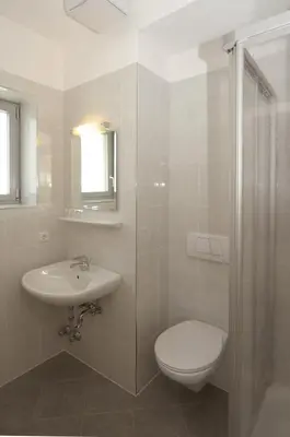 a bathroom with a toilet and a sink at Garni Maria in Varna