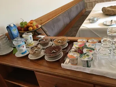 a table with bowls of food and other foods on it at Garni Maria in Varna