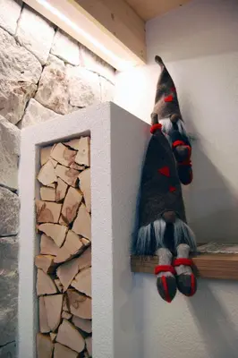 a teddy bear on a shelf next to a stone wall at Ciasa Sas da le Doudesc in Vigo di Fassa