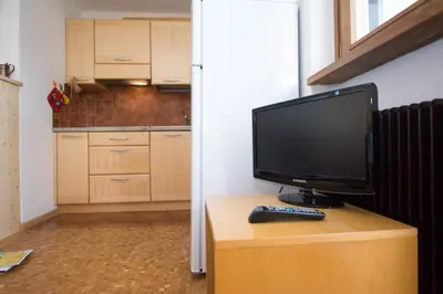 a computer monitor sitting on top of a wooden table at Sass Pordoi in Mazzin
