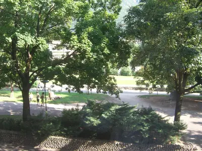 a view of a park with trees and a road at Roma Ariston 8 in Bolzano